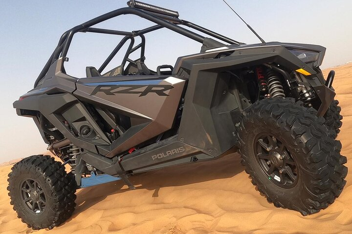 Conquer the stunning red sands of Dubai in a powerful 1000 CC dune buggy experiencing the ultimate desert adventure surrounded by breathtaking views and endless horizons.